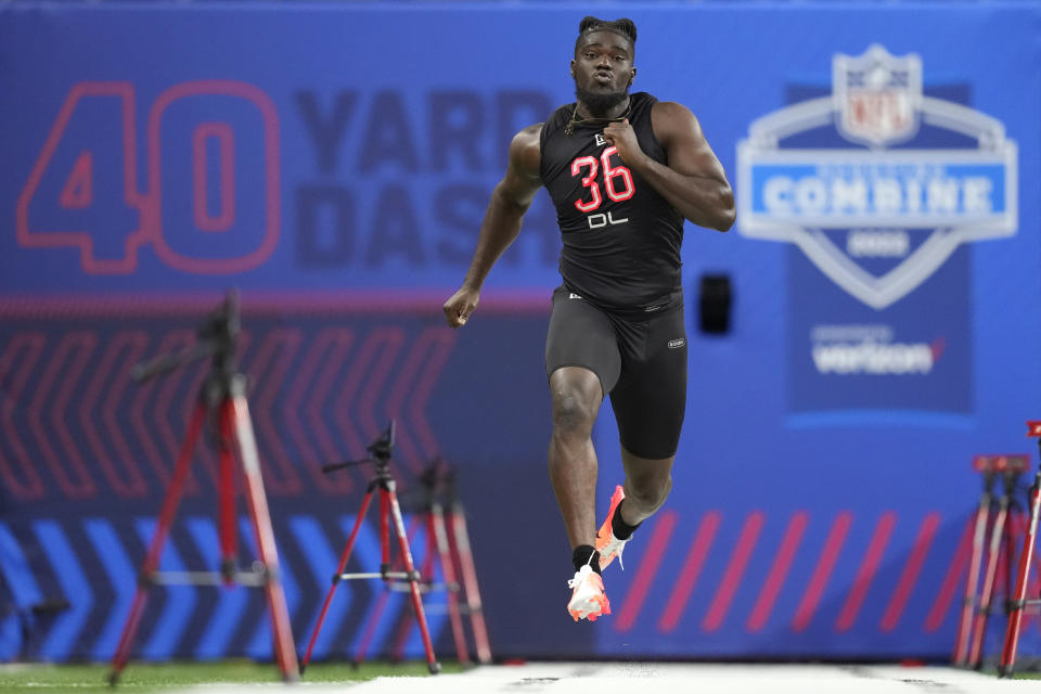 Michigan defensive lineman David Ojabo runs the 40-yard dash at the NFL football scouting combine, Saturday, March 5, 2022, in Indianapolis. (AP Photo/Charlie Neibergall)