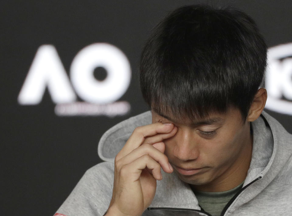 Japan's Kei Nishikori answers questions during a press conference after he retired injured from his quarterfinal against Serbia's Novak Djokovic at the Australian Open tennis championships in Melbourne, Australia, Wednesday, Jan. 23, 2019. (AP Photo/Kin Cheung)