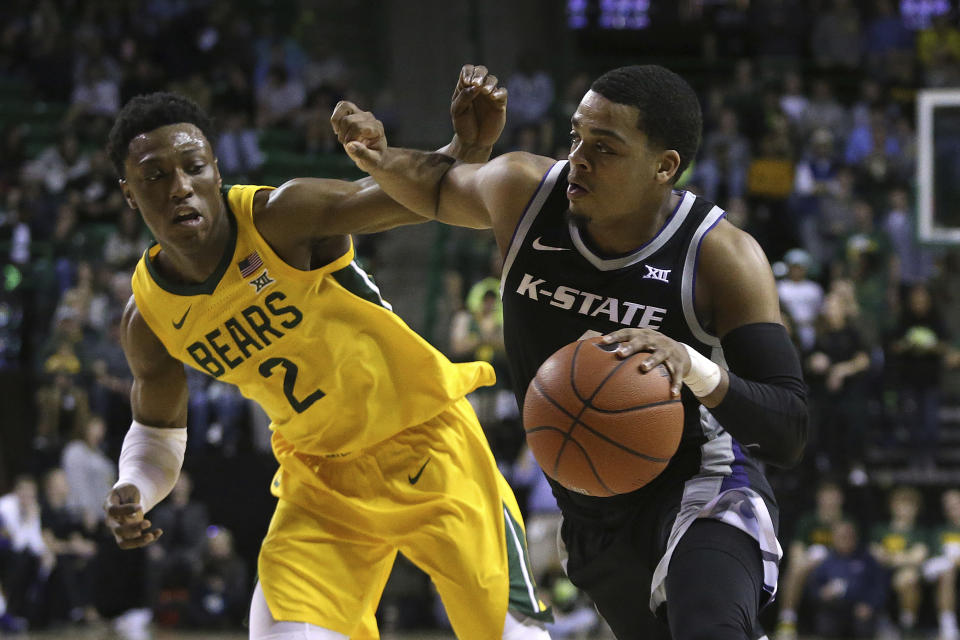 Kansas State guard David Sloan (4) drives the ball against Baylor guard Devonte Bandoo (2) in the first half of an NCAA college basketball game, Tuesday, Feb. 25, 2020, in Waco, Texas. (AP Photo/ Jerry Larson)