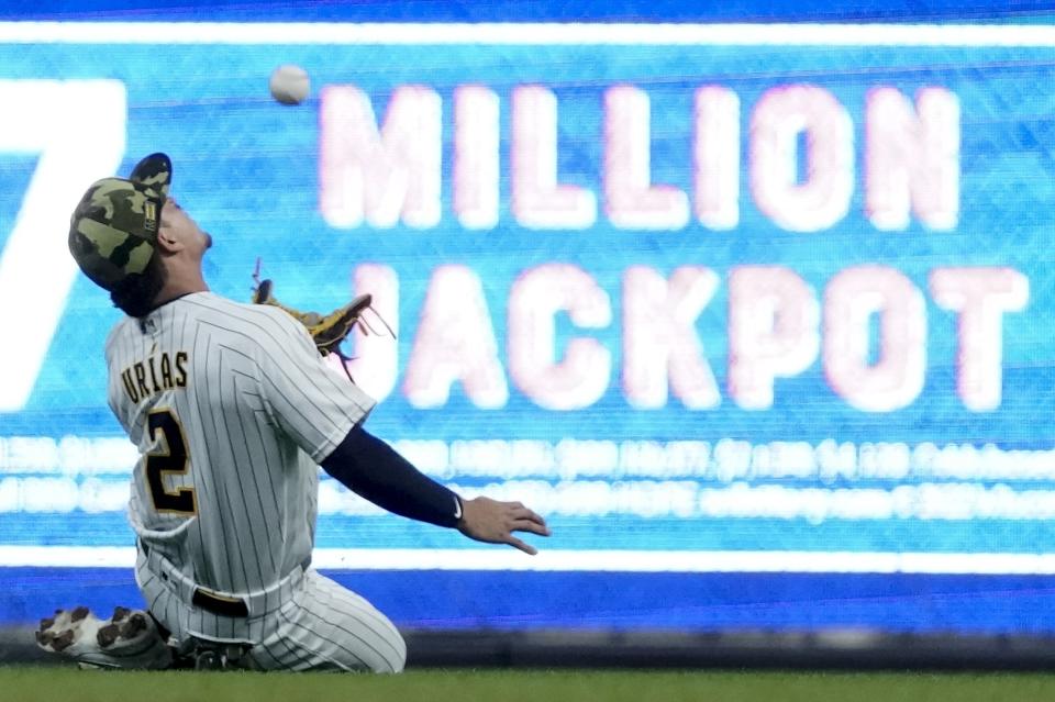 Milwaukee Brewers' Luis Urias makes a running catch on a ball hit by Washington Nationals' Nelson Cruz during the first inning of a baseball game Saturday, May 21, 2022, in Milwaukee. (AP Photo/Morry Gash)