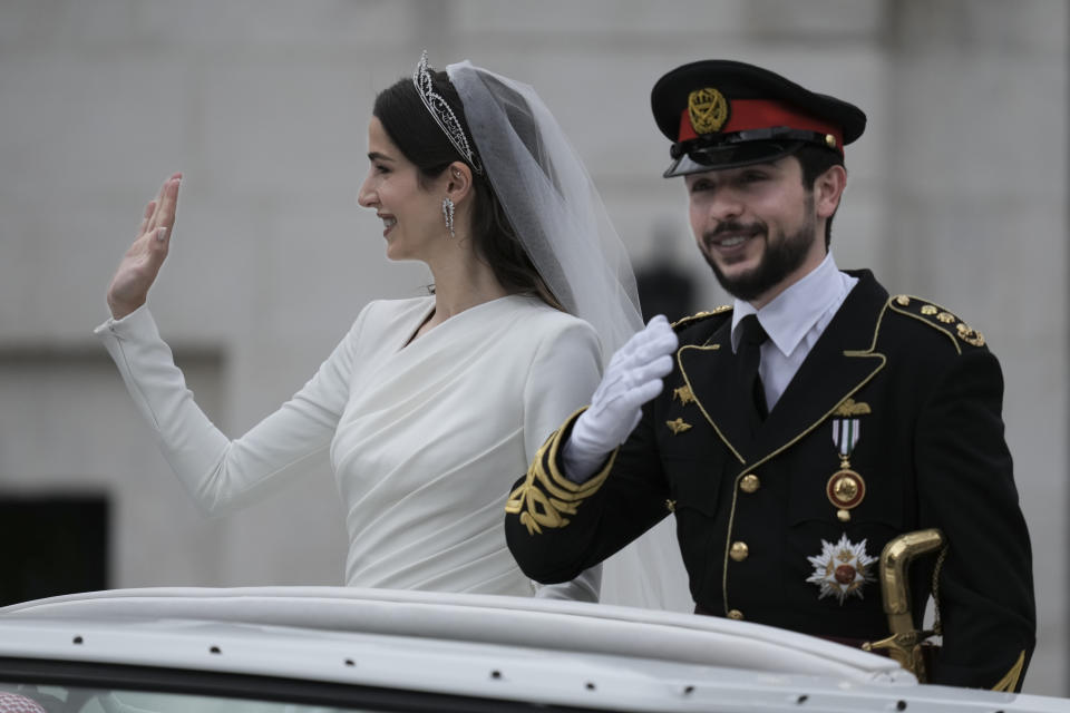 Jordan's Crown Prince Hussein and Saudi Rajwa Alseif wave to well-wishers during their wedding ceremonies in Amman, Jordan, Thursday, June 1, 2023. (AP Photo/Nasser Nasser)