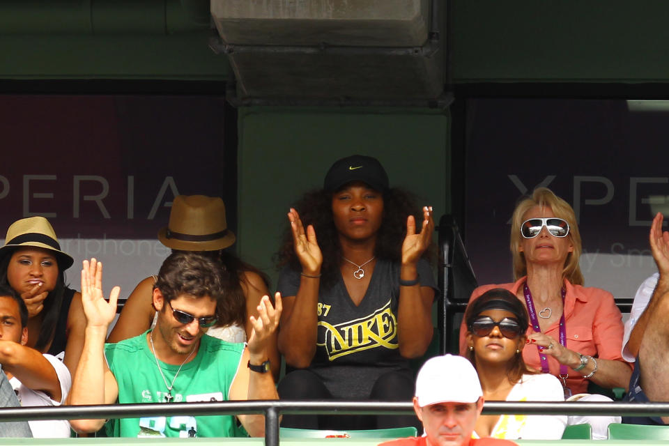 KEY BISCAYNE, FL - MARCH 25: Serena Williams cheers on her sister Venus Williams of the USA against Aleksandra Wozniak of Canada during Day 7 at Crandon Park Tennis Center at the Sony Ericsson Open on March 25, 2012 in Key Biscayne, Florida. (Photo by Al Bello/Getty Images)