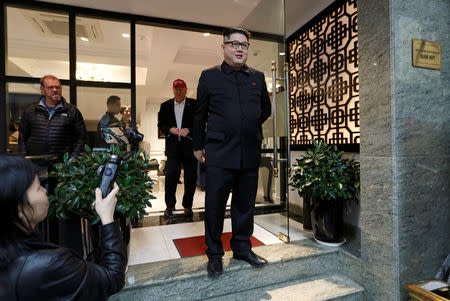 Howard X, an Australian impersonating North Korean leader Kim Jong Un, leaves the La Paix Hotel in front of an impersonator of U.S. President Donald Trump, while escorted by police, in Hanoi, Vietnam February 25, 2019. REUTERS/Jorge Silva