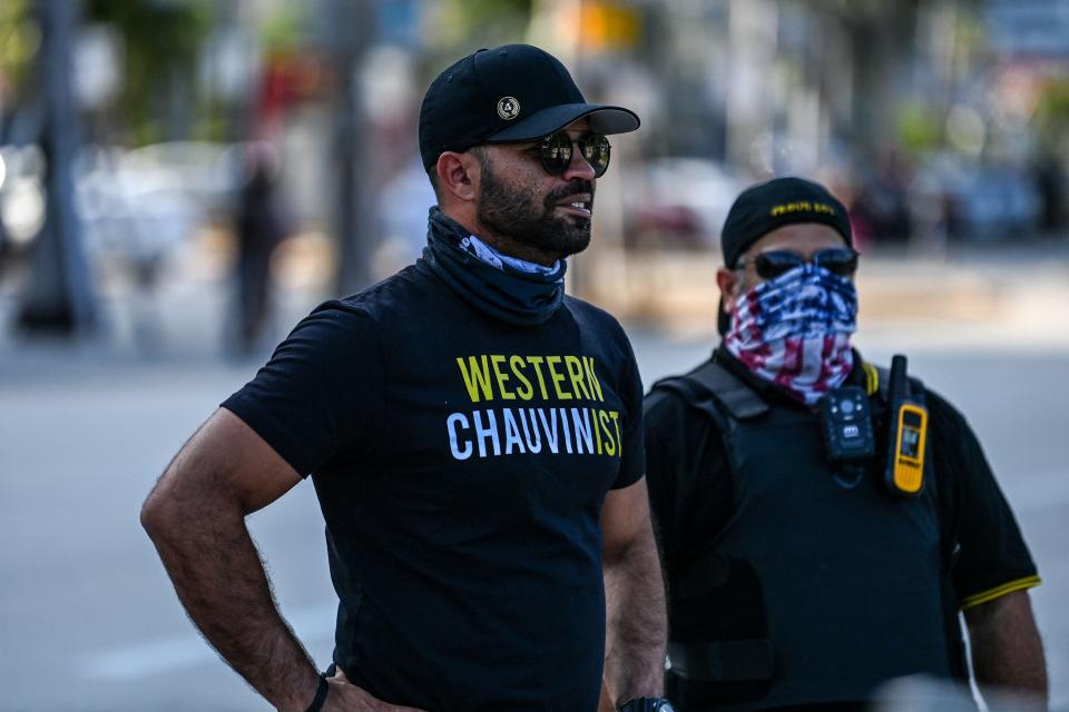 Enrique Tarrio, left, chairman of the Proud Boys, wears a shirt expressing support for Derek Chauvin in a counterprotest against a remembrance of George Floyd in Miami on May 25, the one-year anniversary of Floyd's death at the hands of police officer Chauvin.