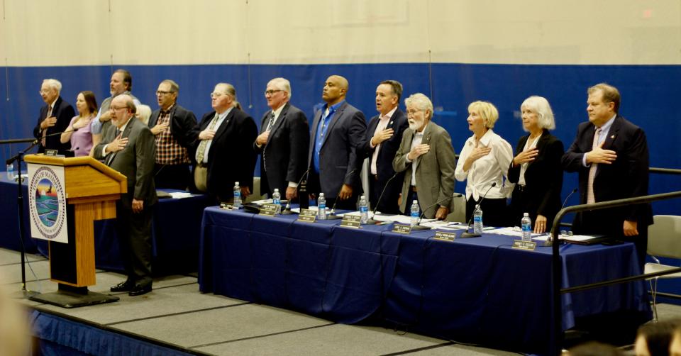 A recitation of the Pledge of Allegiance opened the Mashpee town meeting on Monday. Town Moderator John Miller stands at the podium.