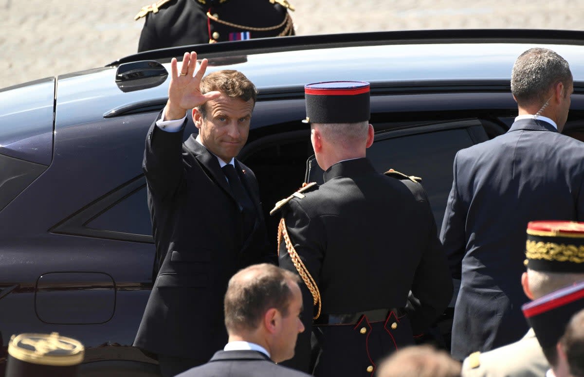 Waving goodbye to Russian gas. French President Emmanuel Macron leaves after attending the Bastille Day military parade on the Champs-Elysees  (AFP via Getty Images)