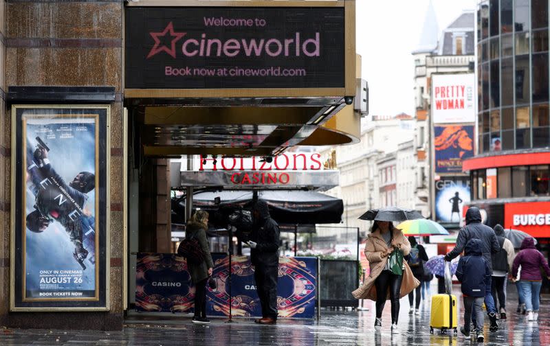 FILE PHOTO: People walk past a Cineworld in Leicester's Square in London