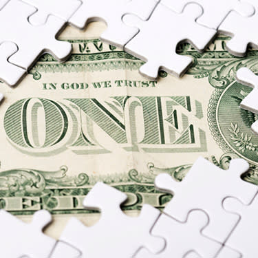 One-dollar-bill-under-white-puzzle_web