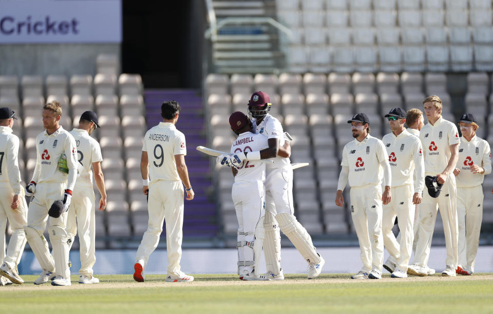 West Indies captain Jason Holder, center right, hugs teammate John Campbell after their win on the fifth day of the first cricket Test match between England and West Indies, at the Ageas Bowl in Southampton, England, Sunday, July 12, 2020. (Adrian Dennis/Pool via AP)