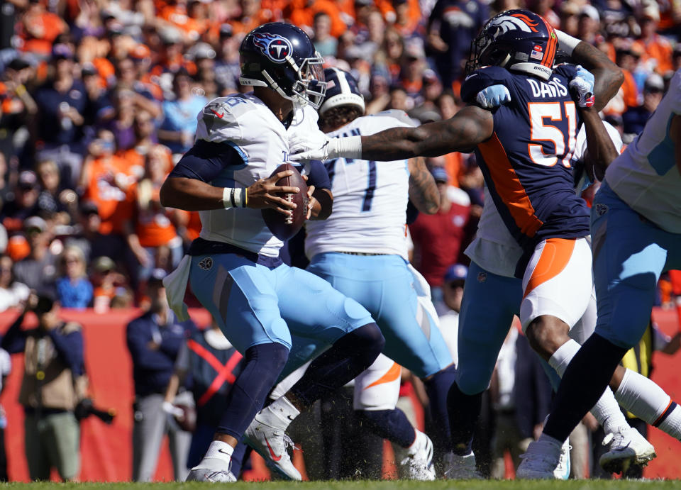 Denver Broncos inside linebacker Todd Davis, right, gets a hand on Tennessee Titans quarterback Marcus Mariota, left, during the first half of an NFL football game Sunday, Oct. 13, 2019, in Denver. (AP Photo/Jack Dempsey)