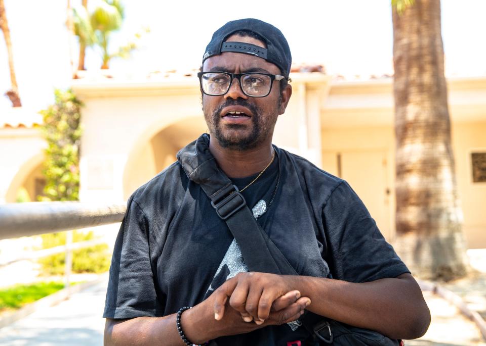 Diamond Love, 32, talks about his experiences living without housing in the desert while standing Wednesday outside Church of St. Paul In the Desert in Palm Springs.