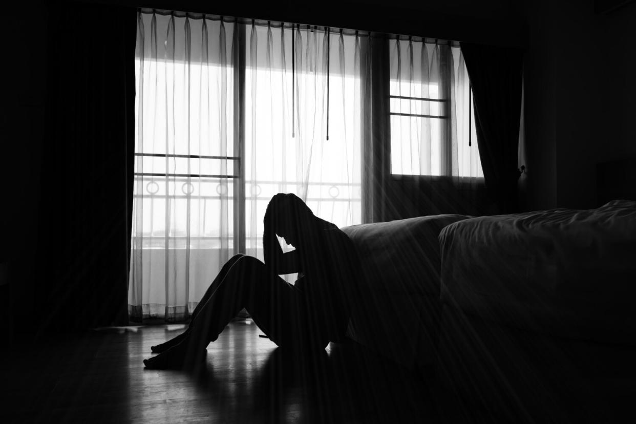 Silhouette of depressed man sitting in the private room