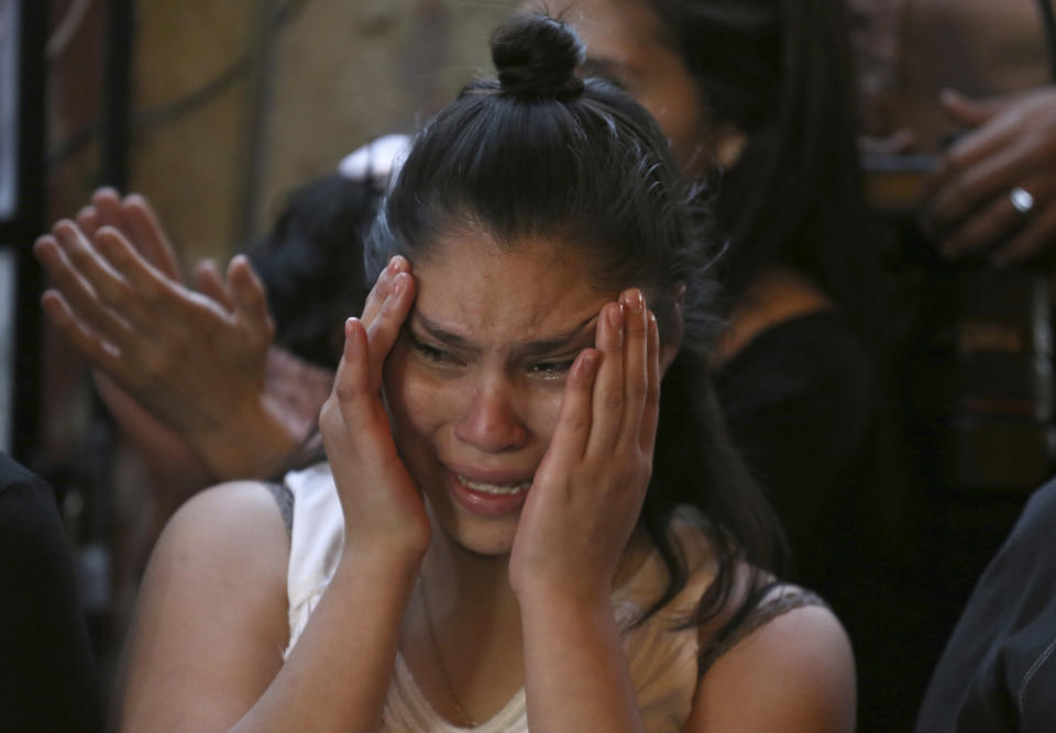 A relative of Fatima, a 7-year-old girl who was abducted from the entrance of the Enrique C. Rebsamen primary school and later killed, cries during Fatima's wake at her home in Mexico City, Monday, Feb. 17, 2020. The girl's body was found wrapped in a bag and abandoned in a rural area on Saturday and was identified by genetic testing. (AP Photo/Marco Ugarte)