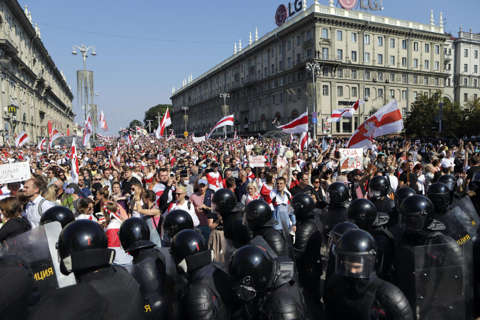 Police block the way for Belarusian opposition supporters rally in the center of Minsk, Belarus, Sunday, Aug. 30, 2020. Opposition supporters whose protests have convulsed the country for two weeks aim to hold a march in the capital of Belarus. (AP Photo)