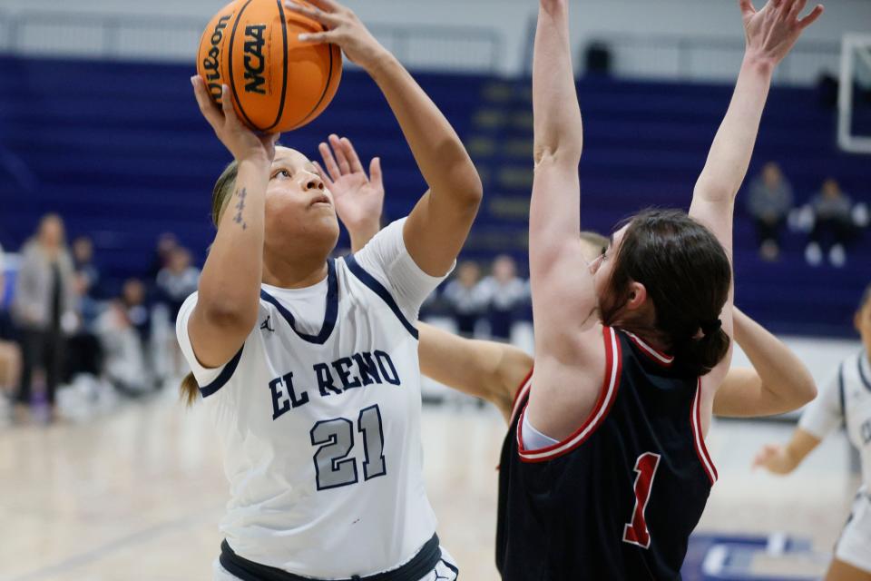 El Reno's Pauline Black-Harmon puts up a shot beside Yukon's Caid Jefferson during the Shawnee Invitational basketball tournament championship game between El Reno and Yukon in Shawnee, Okla., Saturday, Jan. 20, 2024.