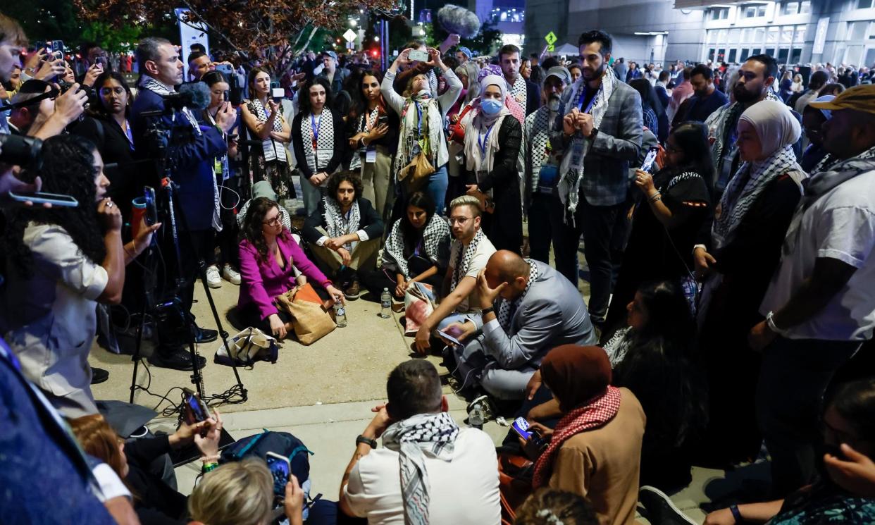 <span>A group of uncommitted delegates hold a sit-in just outside the United Center to protest the lack of a Palestinian American speaker at the Democratic convention.</span><span>Photograph: Caroline Brehman/EPA</span>