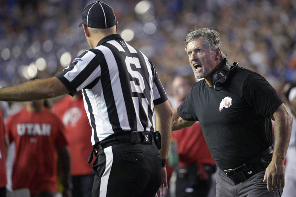 Utah coach Kyle Whittingham, right, argues with an official during the second half of the team's NCAA college football game against Florida, Saturday, Sept. 3, 2022, in Gainesville, Fla. (AP Photo/Phelan M. Ebenhack)