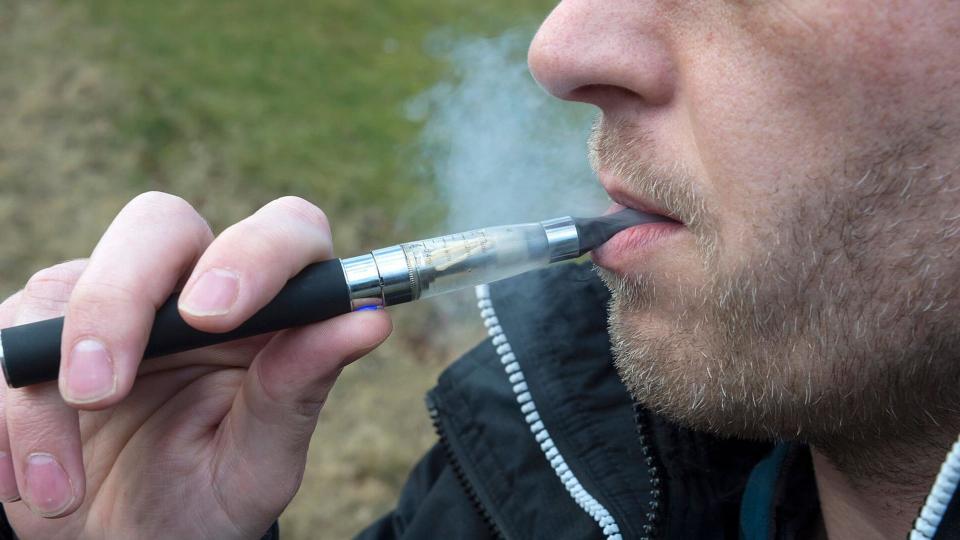 A man smoking an e-cigarette