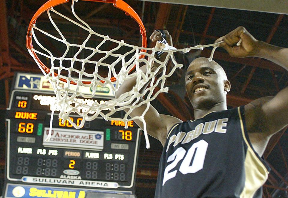 FILe - In this Nov. 29, 2003, file photo, Purdue's Kenneth Lowe, who was awarded the Great Alaska Shootout's MVP award, cuts a strand from the net after Purdue's 78-68 win over Duke at the Great Alaska Shootout basketball tournament in Anchorage, Alaska. Shootout fans over the years witnessed the best of college basketball, with Duke, North Carolina, Kentucky, Michigan State and UCLA winning titles, but the end is near. The 40th Shootout will be the last, a victim of changed rules and competition. (AP Photo/Al Grillo, file)