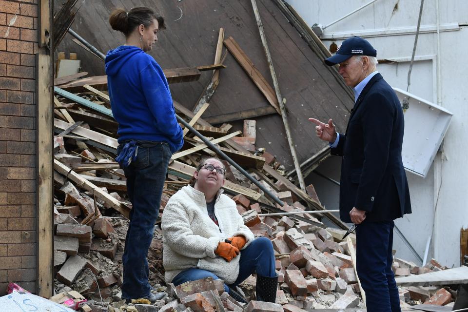 President Joe Biden speaks with a resident as he tours tornado damage in Mayfield, Ky., on Dec. 15, 2021.