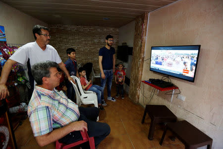 Palestinian refugee Khaled Ali Hassan, 53, watches the Nakba rally on television in Shatila refugee camp, in Beirut, Lebanon, April 19, 2018. REUTERS/Jamal Saidi