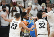 UCLA forward Cody Riley, second from left, pulls in a loose ball as, from left, Colorado forward Tristan da Silva, guard Nique Clifford and center Lawson Lovering defend during the second half of an NCAA college basketball game Saturday, Jan. 22, 2022, in Boulder, Colo. UCLA won 71-65. (AP Photo/David Zalubowski)