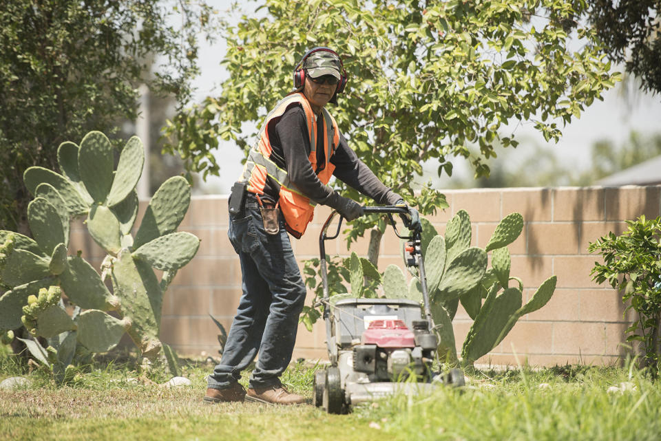 Raudel Felix Garc&iacute;a thinks about how the heat affects him and his landscaping crew on a daily basis. He wears long sleeves and a hat to protect himself from the sun, drinks plenty of water (sometimes upwards of 15 to 20 16 oz. bottles a day), and takes frequent breaks when temperatures are soaring over 100 degrees. (Photo: Melissa Lyttle for HuffPost)