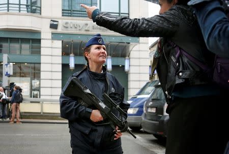 A policewomen gives directions outside the City2 shopping complex which was evacuated following a bomb scare in Brussels, Belgium, June 21, 2016. REUTERS/Francois Lenoir