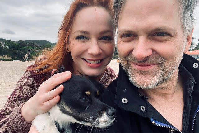 <p>Christina Hendricks/ Instagram</p> Christina Hendricks with George Bianchini and her dog Triscuit.