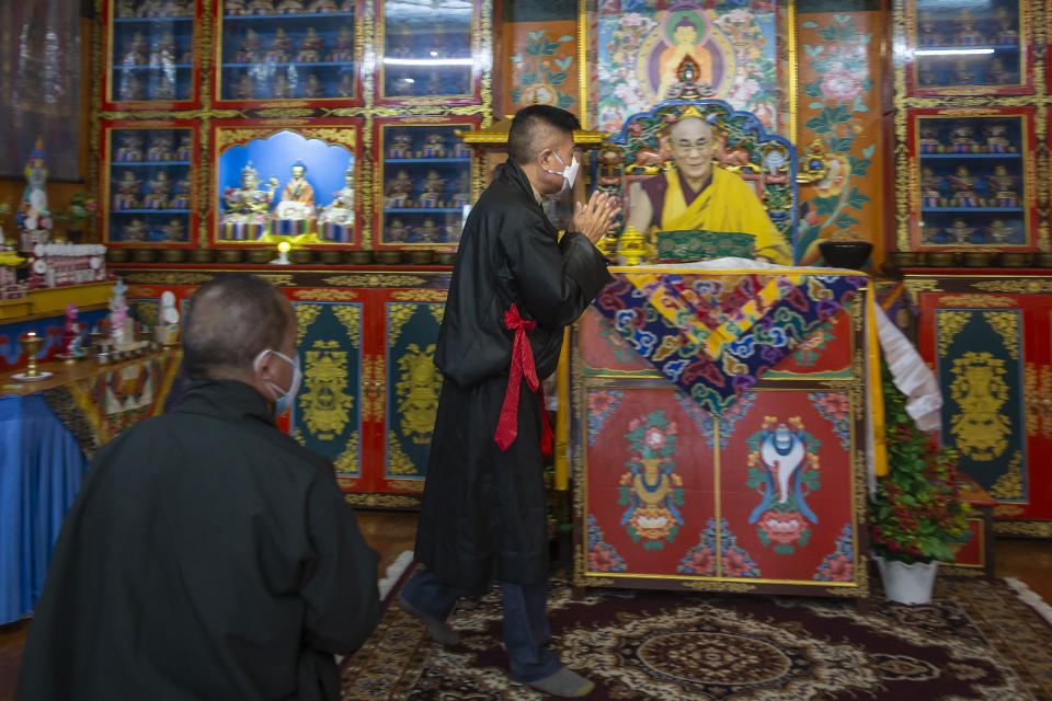 Penpa Tsering, the newly elected President of the Central Tibetan Administration, prays in front of a portrait of his spiritual leader the Dalai Lama in Dharmsala, India, Thursday, May 27, 2021. The new president of the Tibetan exile government said Thursday he was willing to reach out to the Chinese government to resolve their conflict, though the sides haven't had dialogue in the past decade. (AP Photo/Ashwini Bhatia)