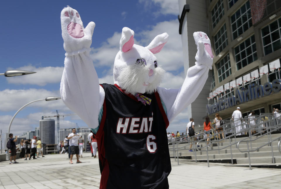 A person dressed as the Easter Bunny wears a LeBron James jersey and waves to fans as they arrive for Game 1 of an opening-round NBA basketball playoff series between the Miami Heat and the Charlotte Bobcats, Sunday, April 20, 2014, in Miami. (AP Photo/Lynne Sladky)