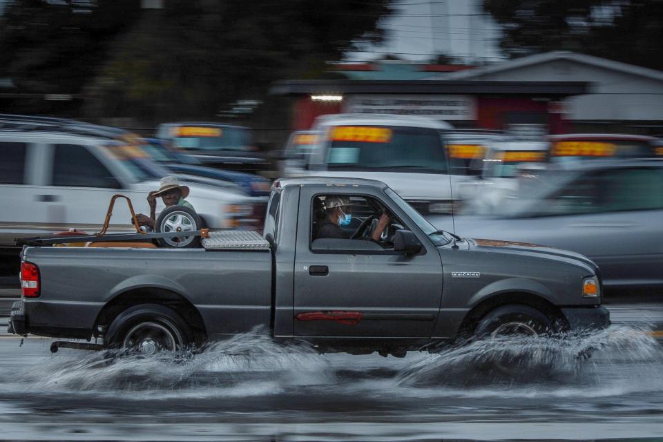 A truck navigated standing water as an afternoon deluge from northeasterly storm clouds swamped the Dixie Highway corridor north of 10th Avenue North Tuesday in Lake Worth Beach.