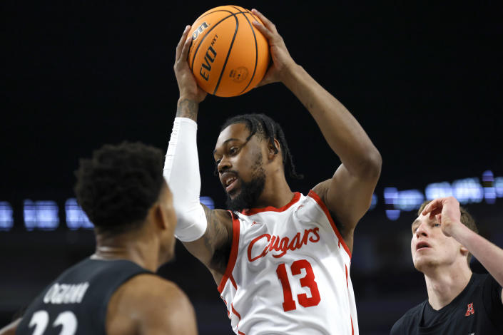 Houston forward J'Wan Roberts (13) rebounds against Cincinnati during the second half of an NCAA college basketball game in the semifinals of the American Athletic Conference Tournament, Saturday, March 11, 2023, in Fort Worth, Texas. (AP Photo/Ron Jenkins)