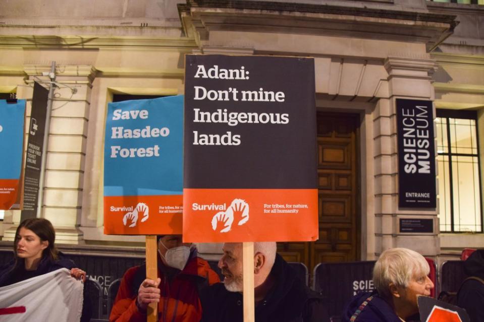 Demonstrators hold 'Save Hasdeo Forest' and 'Adani: Don't Mine Indigenous Lands' placards during a protest in 2022. Demonstrators gathered outside the Science Museum in South Kensington, London, in protest against the sponsorship of the museum's 'Energy Revolution' gallery by coal giant Adani, and in support of indigenous people's rights. <span class="copyright">Vuk Valcic—SOPA Images/LightRocket/Getty Images</span>