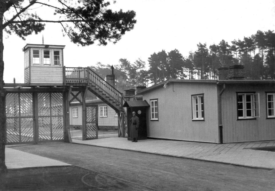 This undated photo from 1941 shows the Gate 3 of the Nazi concentration camp Stutthof in Sztutowo, Poland. a 97-year-old woman charged with being an accessory to murder for her role as secretary to the SS commander of the Stutthof concentration camp during World War II. (Stutthof Museum Archive via AP)