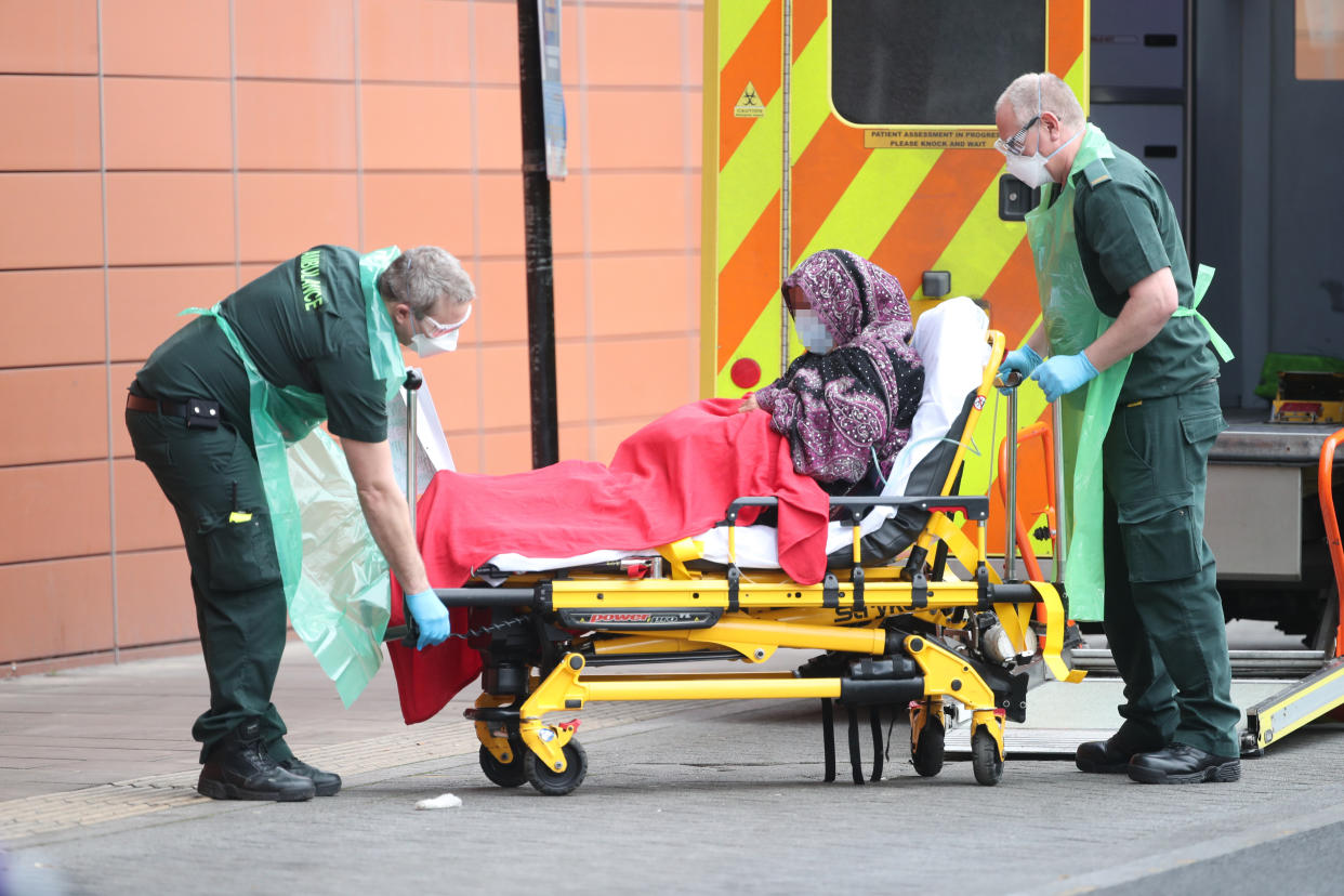 IMAGE PIXELATED BY PA PICTURE DESK Paramedics transport a patient outside the Royal London Hospital in London. A "major incident" was declared by Mayor of London Sadiq Khan last week warning that the spread of coronavirus threatens to "overwhelm" the capital's hospitals.