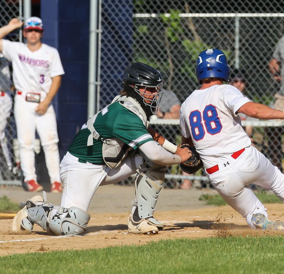 Dover catcher Ryder Aubin applies the tag on Winnacunnet's Ethan Nowak to end the third inning in Thursday's Division I first-round game in Hampton.