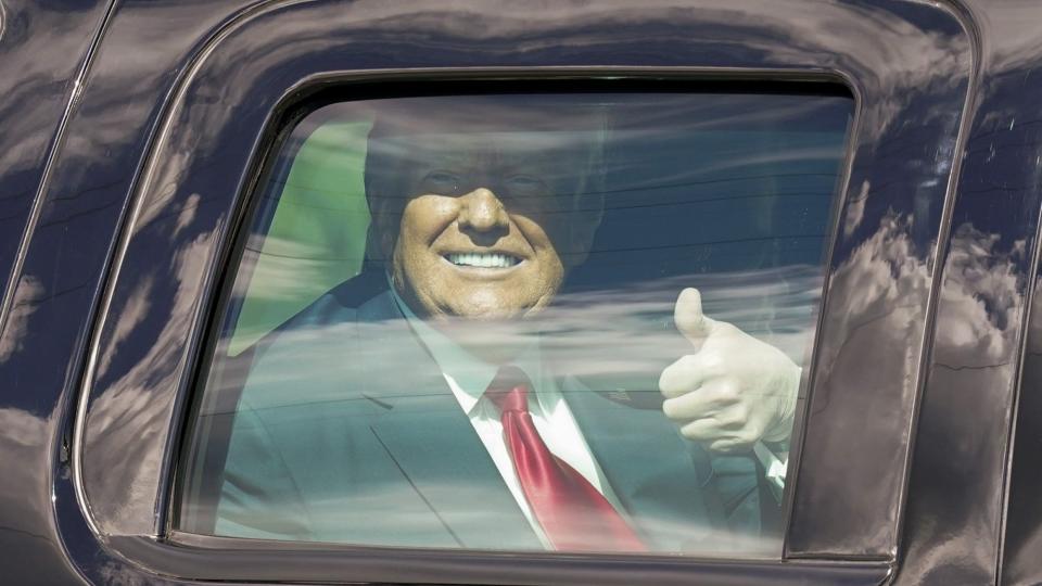 <p>The former POTUS gives a thumbs-up while driven from the airport to his new home.</p>