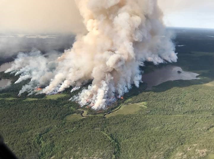 Wildfires like the one pictured, called Kenora 51, are burning in northwestern forcing evacuations of a number of communities due to air quality impacts and threaten fire behaviour.