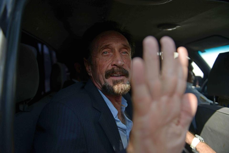 US anti-virus software pioneer John McAfee gestures as he arrives at the Aurora international airport in Guatemala City. McAfee escaped immediate deportation to Belize on Wednesday as Guatemala decided to expel the American back to the United States instead. McAfee, who entered Guatemala illegally after more than three weeks on the run, is wanted in Belize for questioning over his neighbor's murder last month. JOHAN ORDONEZ/AFP/Getty Images