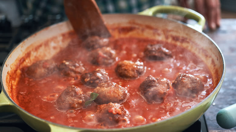 Meatballs simmering in tomato sauce