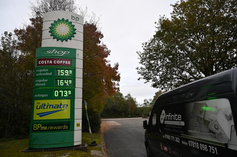 A sign displays the price per litre of petrol and diesel fuels, outside a filling station on the M23 motorway 