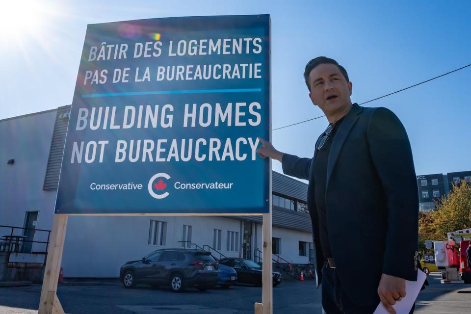 Conservative Leader Pierre Poilievre points at his message at a press event in Vancouver. B.C., Thursday, Sept. 14, 2023.