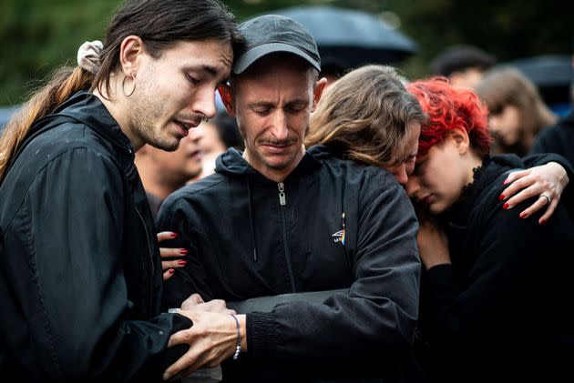 Participants embrace during a protest in downtown Bratislava on Oct. 14, 2022, two days after a 