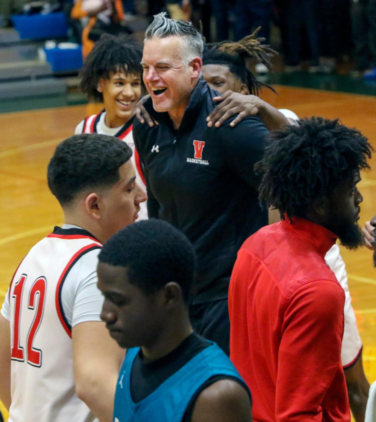 Victory Christian coach Steve Fitzgerald is congratulated by his players after winning his 500th career game in the Story's win over Olympia.