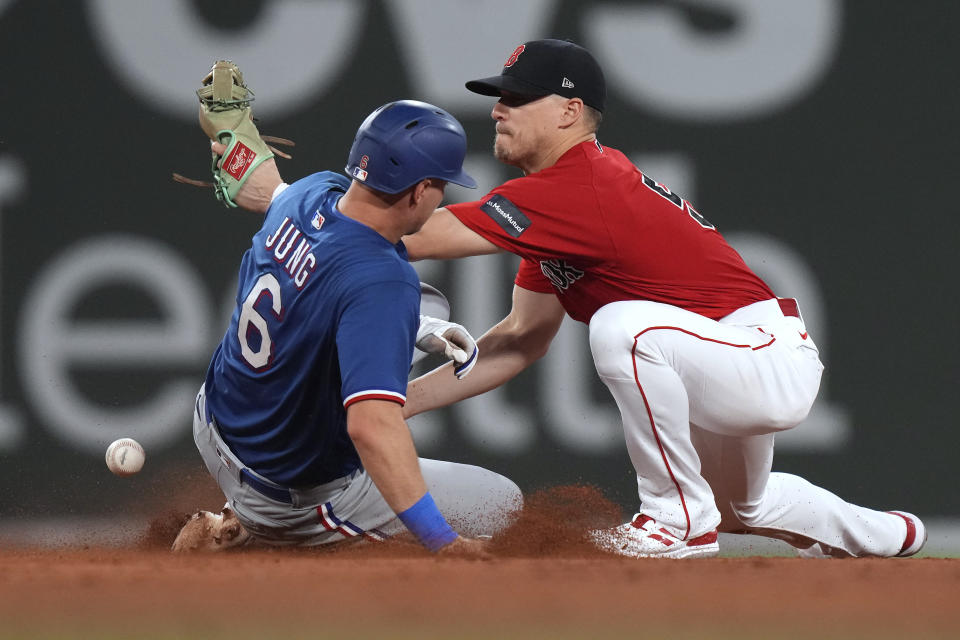 Texas Rangers' Josh Jung (6) is safe at second with a double as Boston Red Sox's Enrique Hernandez, right, tries to get his glove on the ball during the fifth inning of a baseball game Thursday, July 6, 2023, in Boston. (AP Photo/Steven Senne)