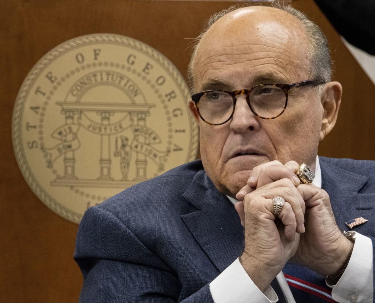 Rudy Giuliani listens to testimony during a subcommittee of the state Senate judiciary committee meeting at the State Capitol in Atlanta on Thursday, Dec. 3, 2020. 