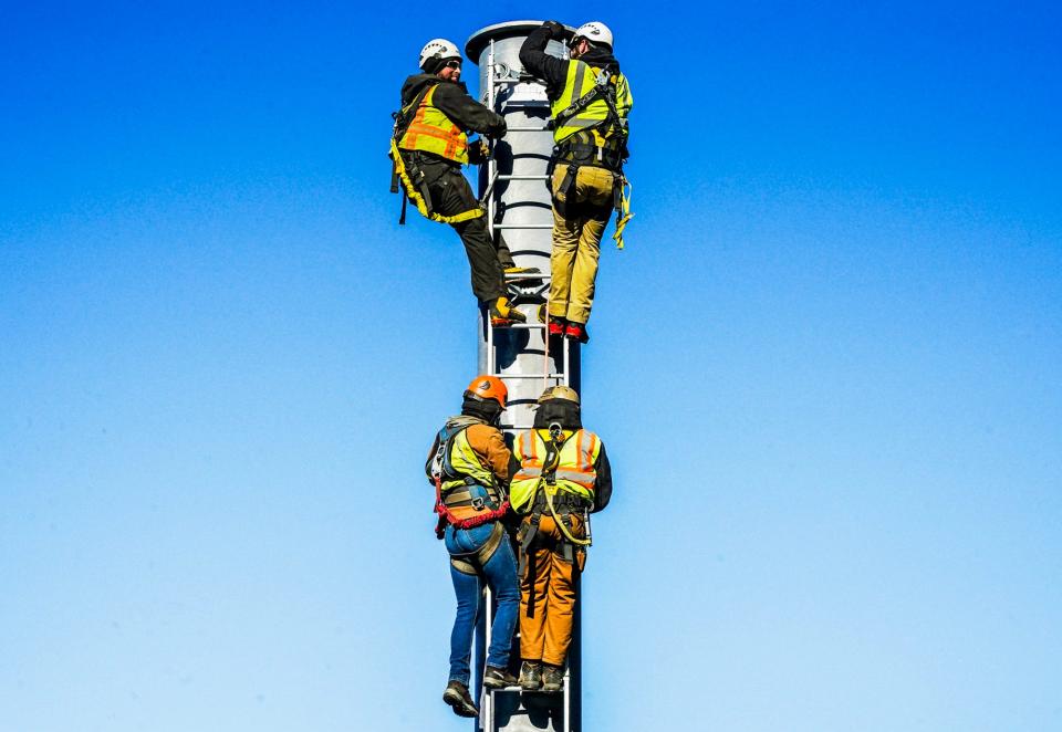 Earlier this month, men work on the new Mountaineer high-speed quad summit lift under construction at Attitash Mountain in Bartlett, New Hampshire.