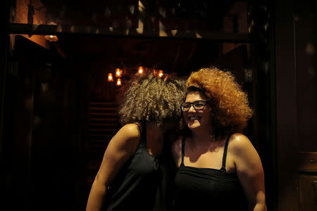 Two women talk to each other in a bar in the Old City of Damascus, Syria, September 13, 2018. For much of the war the eastern Ghouta rebels fired mortars into Damascus, including the Old City, where shrapnel marks are often visible scored into streets or walls. Cafes spill out onto the cobbled streets of the Old City at night as carefully coiffed barbers give fashionable haircuts to young men, and groups of friends gather to play guitars. REUTERS/Marko Djurica