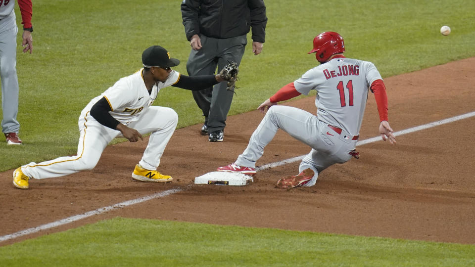 St. Louis Cardinals' Paul DeJong (11) takes third as the throw from Pittsburgh Pirates center fielder Ji Hwan Bae is up the line from third baseman Ke'Bryan Hayes during the seventh inning of a baseball game Tuesday, Oct. 4, 2022, in Pittsburgh. (AP Photo/Keith Srakocic)
